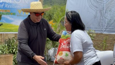 Greenstone’s President and Concurrent General Manager Engr. Anthony Quijano handing out a sack of rice as a part of the company’s continuous support to the Siana Residents.