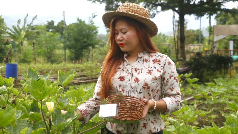 Agata's Mabakas Techno Demo Farm Community Livelihood Specialist Maritonie Niño uses the community's handmade basket as she harvests vegetables at the Mabakas Farm Garden.
