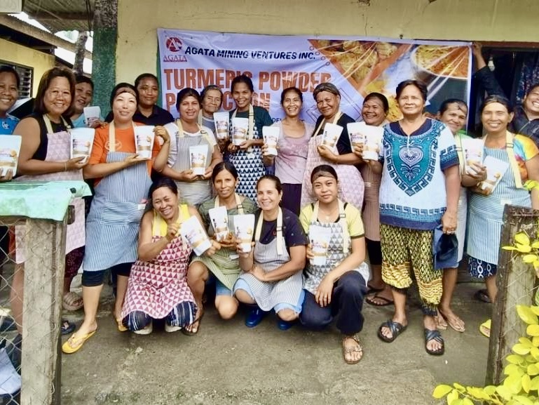 A Group of mothers who are beneficiaries of Agata's livelihood program on producing Turmeric Powder show their finished product at the tail end of the course.