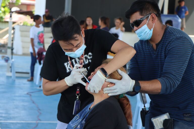 TVIRD Balabag resident dentist, Dr. Royce Dagdag, DMD, conducts a basic tooth extraction procedure on a Depore resident.