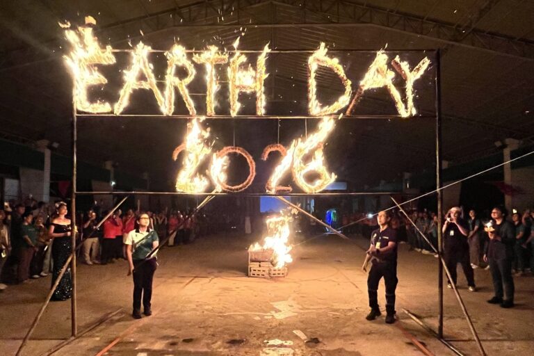 Lighting the symbolic flame of the Earth Day celebration. TVIRD Environment Director Jesalyn Guingguing and Security Director Edgardo Amores light the Annual Earth Day banner at the Siana Gold Project.