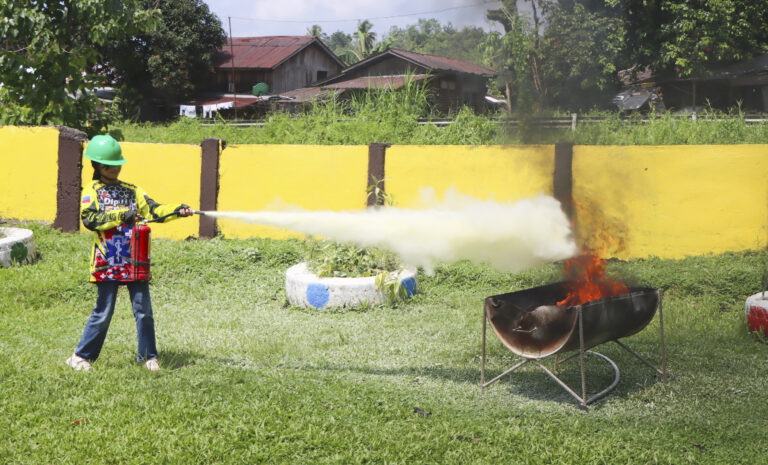 A Dipili Mini-ERT member learned how extinguish fire using the Point-Aim-Squeeze-Sweep (PASS) method. Students learned what to do during fires and other hazards.