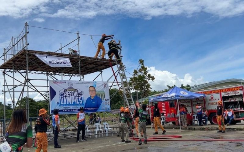 Team members climb the tower and pump water towards a target during the Tower Blitz Competition.